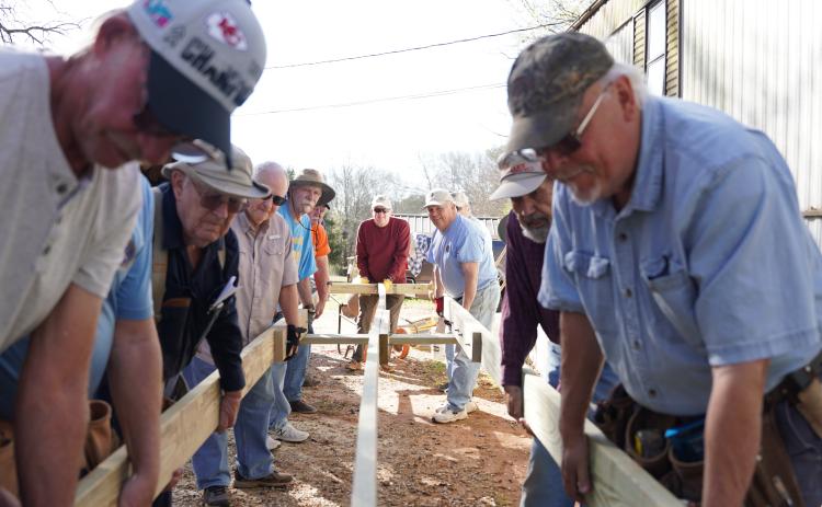 Members of Hart County’s Golden K club lower the framing into place for a new ramp at a local resident’s house on Tuesday. The ramp marked the group’s 800th access ramp built within the community.