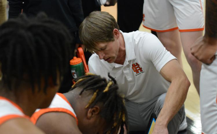 Dogs head coach Matt Gibbs draws up a play during a home game from earlier in the season.