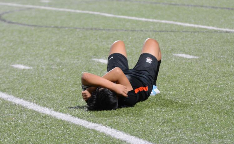 Senior left defensive back Jonathan Velazquez lies down after giving it his all in his final game for Hart County. As the Dogs lose 7-1 on the road to Wesleyan in the first round of the state playoffs.