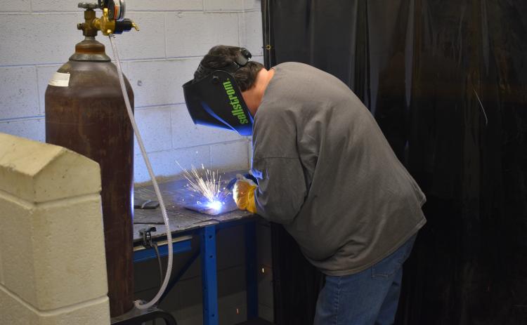 Sue Couch, a participant in the second installment of the adult welding class, works on her final project at the end of the four-week course.