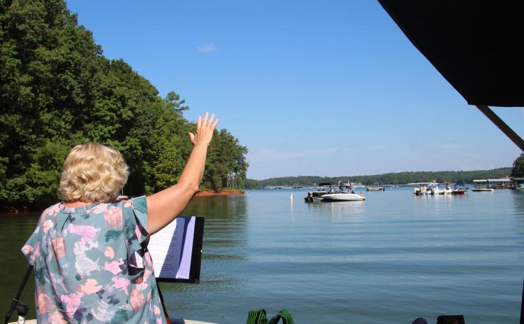 Worship leader Sherry Lewis is shown speaking at one of the services held during the first season of Water’s Edge Ministry at Lake Hartwell.