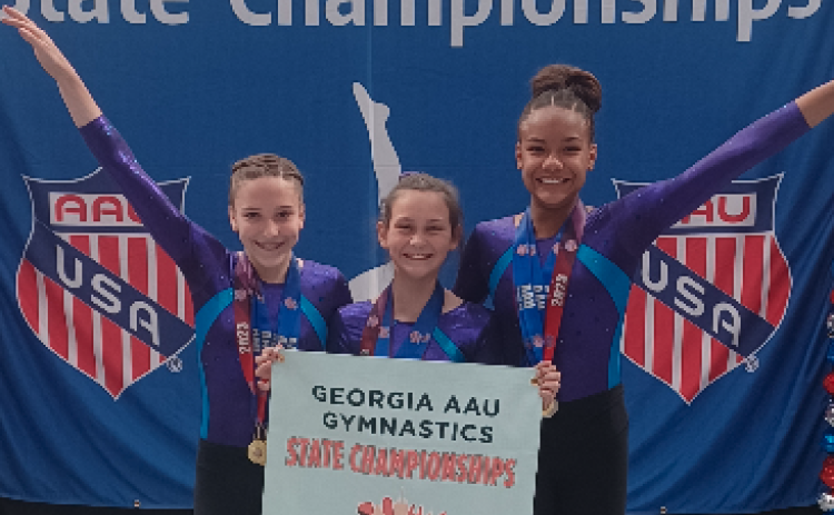 Pictured from left to right Madalyn Dault, Maci Dudley, Cheyenne Rucker who are the XCEL Diamond state champions.