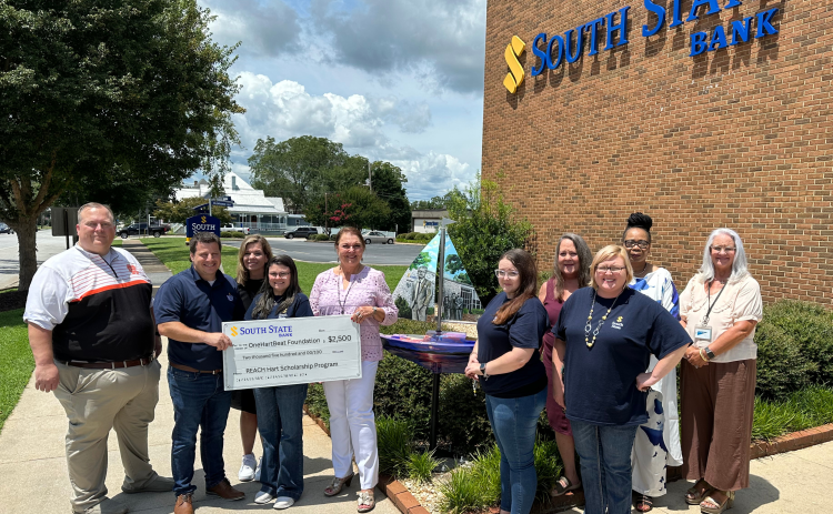 Pictured, from left to right, are HCHS Principal Kevin Gaines, South State Branch Manager Justin Price, HCMS Principal Jacqueline Brock, South State employee Samantha McClure, OneHartBeat Foundation Director Bobbie Busha, South State employees Kayla Poole, Lisa Pickett, Wendy Holcomb, Karen Leverett, and OneHartBeat Foundation Board Member Wyndee McKinnon.