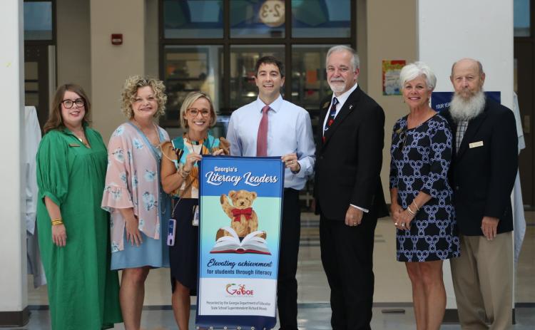 State School Superintendent Richard Woods, pictured third from right, presented North Hart Elementary School with a Literacy Leader banner on September 19, 2023. Pictured, from left to right, are Hart County Board of Education Chair Kim Pierce, Hart County Superintendent Jennifer Carter, NHES Principal Christina Weir, NHES Assistant Principal Marion Hanahan, State School Superintendent Richard Woods, Hart County Board of Education member Henley Cleary, and Hart County Board of Education member Dennis Dowell