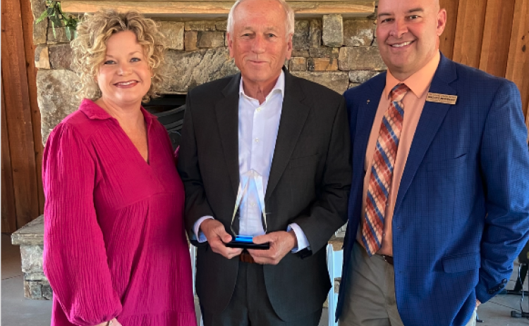 Photo to the left: Mr. Charles Corbett, center, who was named this year’s ‘Pioneer in Education’, poses for a photo alongside Superintendent Jennifer Carter, left, and Associate Superintendent Brooks Mewborn, right.