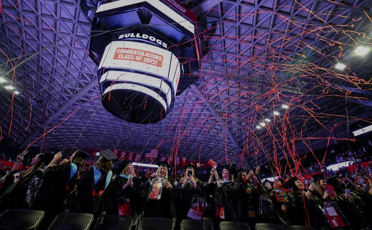 Streamers fly at the end of the 2022 graduate Commencement ceremony in Stegeman Coliseum