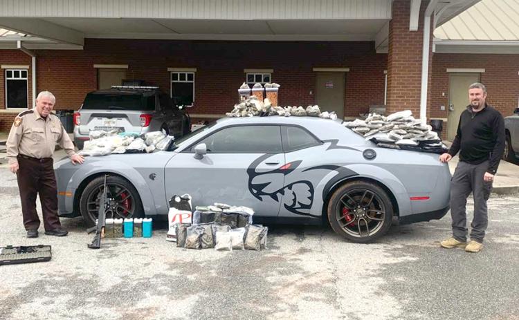 Hart County Sheriff Mike Cleveland (left) and Capt. Chris Carroll stand with the seized “Jail Break Hell Cat” Dodge Challenger, drugs and weapons. The Jan. 17 incident comes in at number six on our list.
