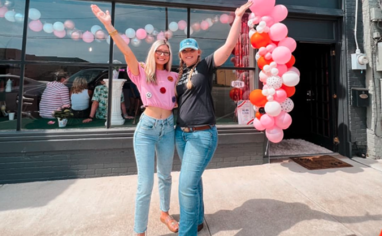 Owners of Happy Hounds Faith Phillips (left) and Breanna Shattles (right) celebrate the opening of their pet grooming business on Depot Street in Hartwell in May of 2023.