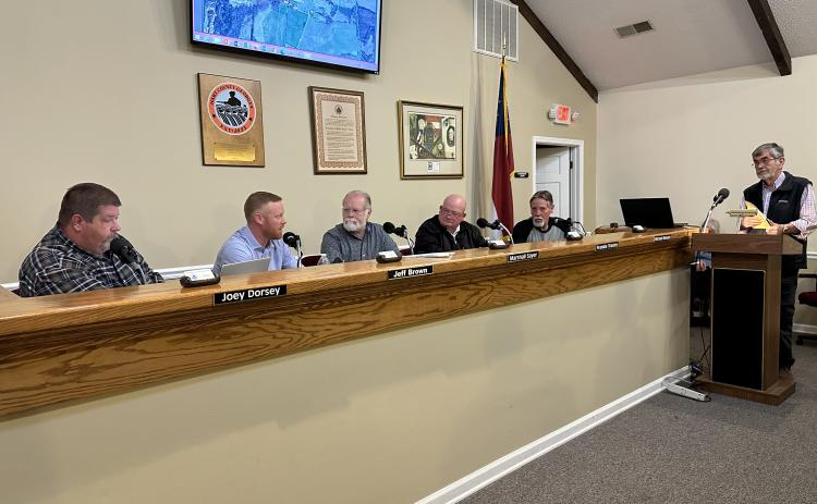 The Board of Commissioners speaking with Terrell Partain, county administrator, at their meeting Feb. 27.