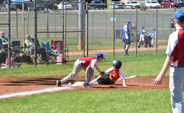 Xavier Robinson (right) slides into third base on Opening Day for Hart County Little League.