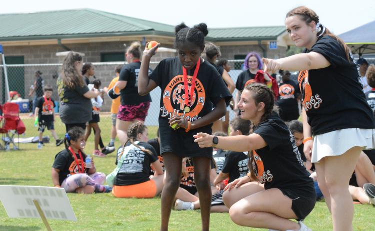 Pictured from left is sophomore Special Olympic athlete Abigal Kent alongside senior Sage Robach and junior Katie Sanders at the ball throw at the Special Olympics April 17.