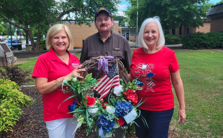 Left to right: Beth Mewborn Commander James Fulghum American Legion post 109, Jeanne Alpers Service League ladies put a wreath at the WWII Monument for Memorial Day.