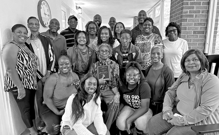 The Senior Center’s longest-attending member, Idell Morrison (center), surrounded by her family and holding the plaque that will hang in the new porch in her honor.