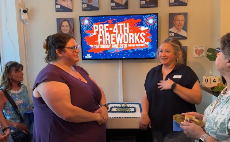 Rachel Black /The Hartwell Sun Hart Chamber of Commerce Executive Director Lindsey Ingle (right) and Assistant Director Amanda Brown speak to community members during the Chamber’s 75 anniversary ceremony June 4.