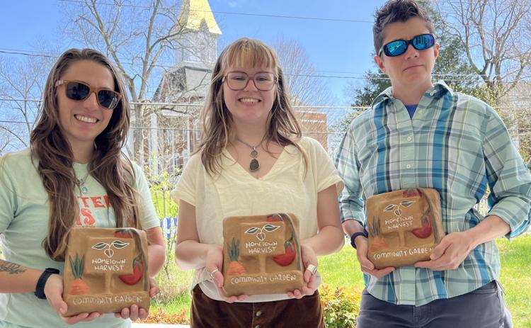Hartwell’s Jennie Bosman, center, donated four pavers she designed and created to the Vickery House garden, poses with Morgan Southerland, Hometown Harvest coordinator, left, and Kelly West, director of UNG’s Appalachian Studies Center.