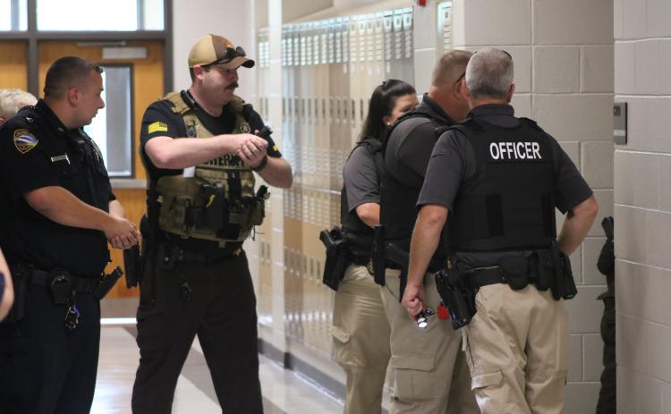 Local law enforcement sweep the building during an active shooter simulation drill at Hart County Middle School.