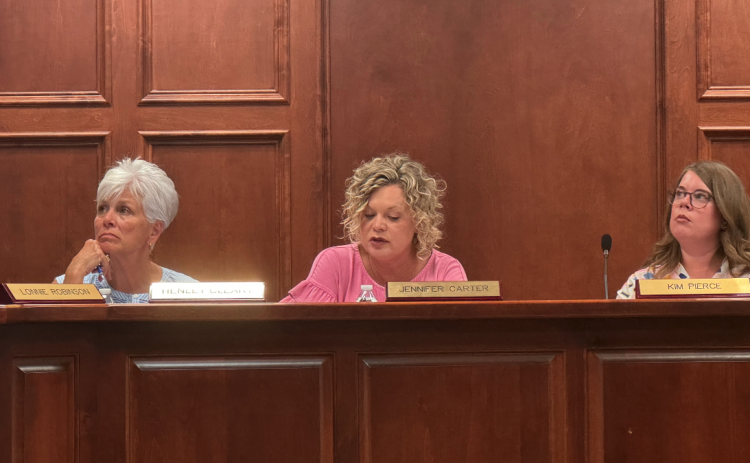 From left to right: Board member Henley Cleary, Superintendent Jennifer Carter, and Board Chair Kim Pierce review amended policy recommendations .
