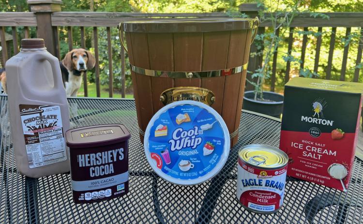 Sparky, the family’s Treeing Walker hound, spies the fixings for Tallulah chocolate on the NeSmiths’ backyard deck in Habersham County.
