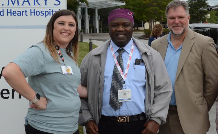 More than 100 healthcare professionals, First Responders and community leaders attended a barbecue sponsored by St. Mary’s Sacred Heart Hospital and Surgical Affiliates Management Group Inc. to celebrate the surgery program’s expansion into elective surgeries. Pictured are (from left) clinic coordinator Ashlee Dove, Dr. Abdul Bangura and David Van Laecke, AMGI vice president of operations. Photo by Charlie Eavenson/Franklin County Citizen