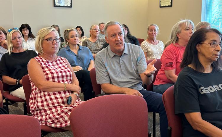 Community members such as Dan Casey attended the Sept. 9 Hartwell City Council meeting to voice concerns about the firing of former Chamber of Commerce Executive Director Lindsey Ingle (located behind Casey, in blue).