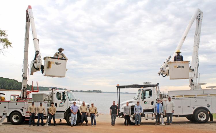 Hart County is serviced by two companies  for their electricity needs. On the left, is a crew from Georgia Power including (from left to right): Ethan McCleery (Apprentice lineman), Clarke Looney (supervisor), Freddy Arteaga (apprentice lineman), Jayson Summers(engineer), Mitch Turpin (lineman), Keith Vickery (lineman), and the bucket is Vladimir Flor-Huerta (apprentice lineman). On the right is a crew from Hart EMC including: David Craft, Jared Dove, Sam Findley, Joey Fowler, Caden Hart , and Shaun Martin