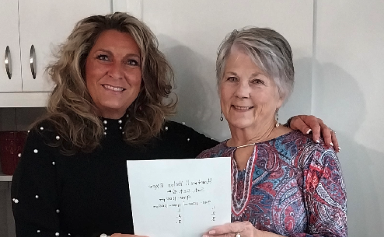 Linda Gunter (left), CEO and Co-founder of Love Him Love Them stands with Claudia Kay, Local Assistance Coordinator as they look over details for their Thanksgiving event.