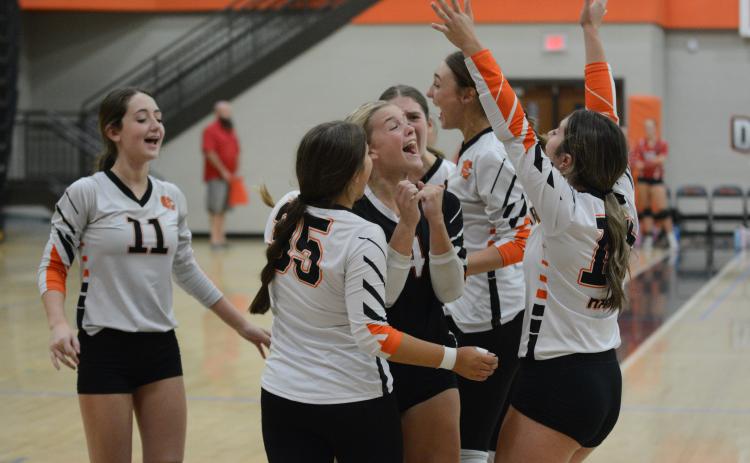 The Volley Dogs celebrate after defeating Westside of Anderson, S.C. in three sets: 27-25, 23-25, and 15-12.