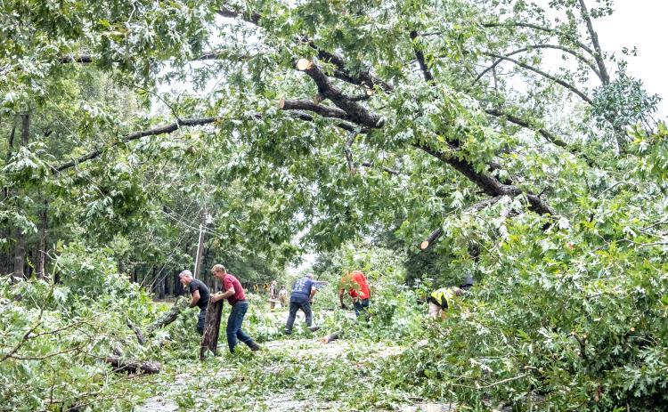Hart County’s first responders and residents come together to clean up storm debris and downed power lines along Lightwood Rd. Friday following Hurricane Helene. Photo by Bill Powell/The Hartwell Sun