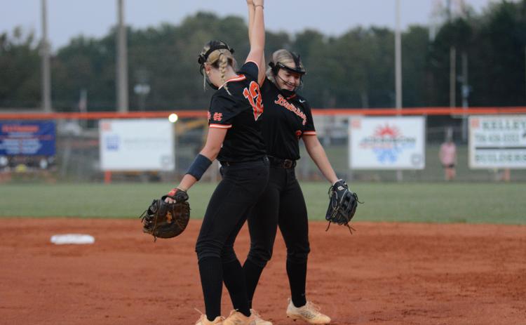 Junior first baseman Kinsley Duncan and sophomore second baseman Carly Dutton celebrates after a 2-0 shutout win over the Lady Tigers of Commerce on Senior Night Sept. 30.