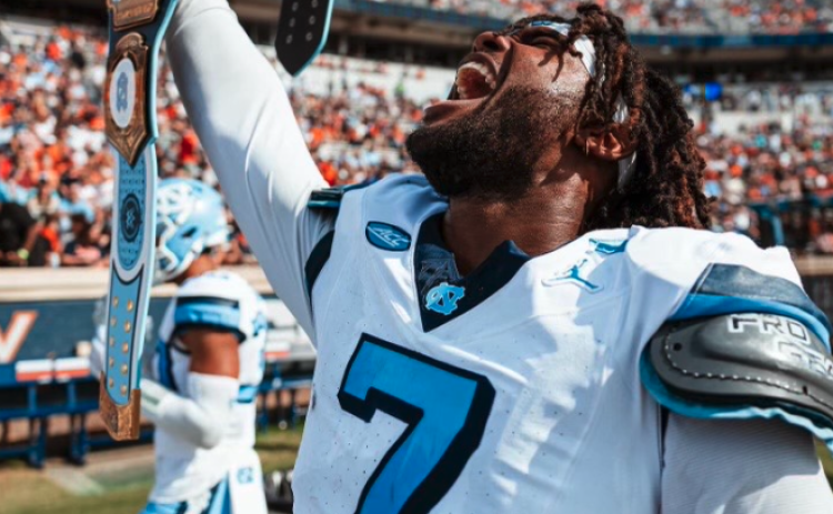Former Bulldog and current UNC defensive end Kaimon Rucker holds up the UNC WWE turnover belt after collecting an interception in the Tar Heels 41-10 win in Charlottesville against the Cavaliers of Virginia. Photo by UNC Athletics.