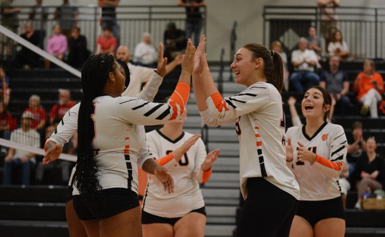 The Volley Dogs celebrate after the 3-1 win over Stephens County in the first round of the Region Tournament Oct. 10.