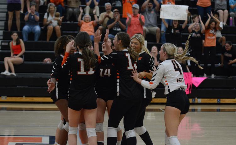 The Volley Dogs celebrate after a 2-0 win (25-21 and 25-19) against Prince Avenue Christian on Oct. 8 to secure a home game in the first round of the region tournament that begins on Oct. 10.