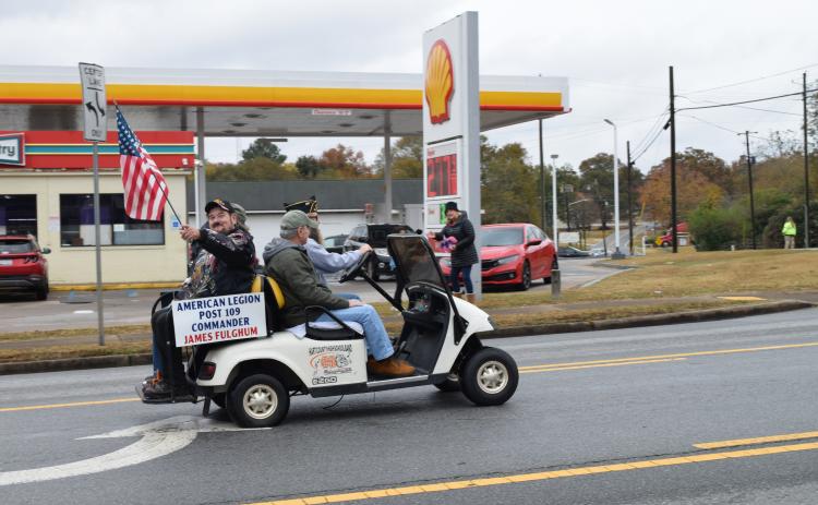 American Legion Post 109 Commander James Fulghum waves the flag during the 2023 Hartwell Veterans Day Parade.