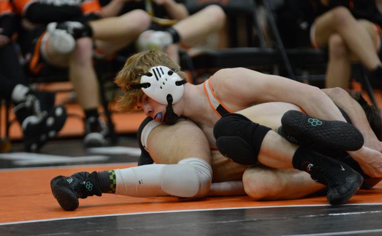 Senior Harrison Krause looks to pin his opponent during a home meet in 2023-2024.