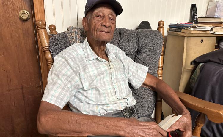 Clifford Jones, a World War II veteran, holding his honorable discharge letter from 1946. 
