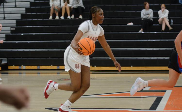 Junior forward Kiasia Montgomery dribbles the ball up the court in the 60-29 win over Oglethorpe County on Nov. 7.