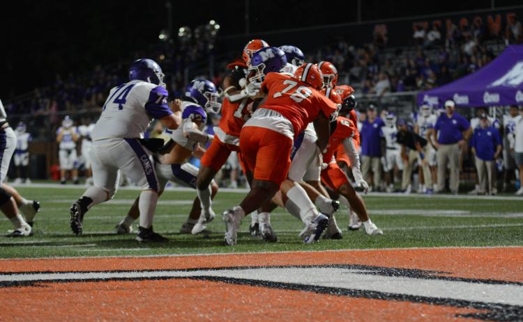 Junior defensive tackle Nicholas Carter (78) sacks the quarterback in the 28-21 win over Monroe Area.