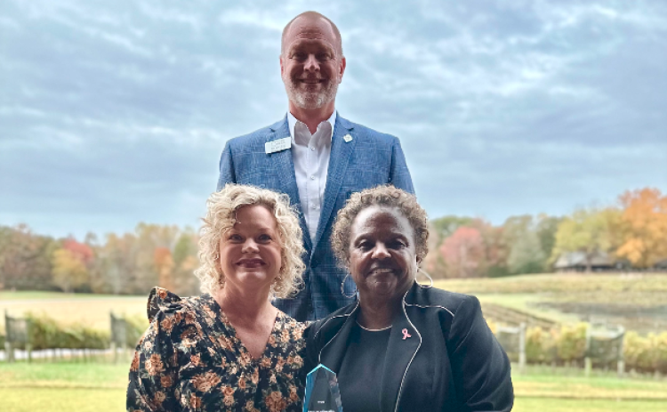 Pictured, seated, from left to right, are Hart County Charter System Superintendent Jennifer Carter and Dr. Veronica Johnson, this year’s Pioneer in Education, with Pioneer RESA Executive Director Tim Cochran, standing.