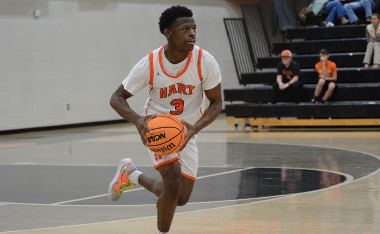 Senior guard Andrew Maxwell looks to pass the ball in the 67-36 win over Athens Academy on Dec. 10.