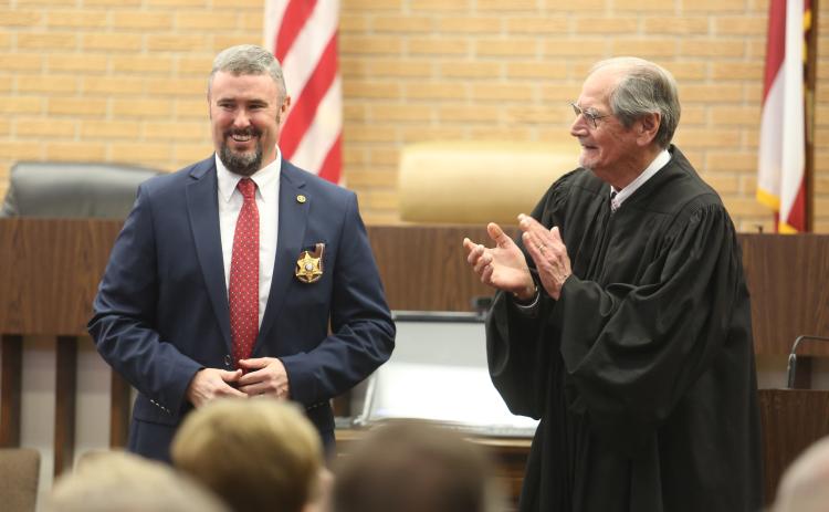 Northern Judicial Circuit Superior Court Judge Chris Phelps (right) claps for Hart County Sheriff Chris Carroll (left) after swearing him into office Dec. 30 inside the Hart County Courthouse.