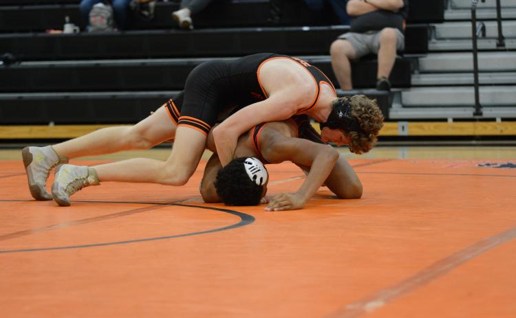 Senior Ethan Stovall pins his opponent to help the Mat Dogs rally back in the 48-34 win over Harlem on Nov. 20.