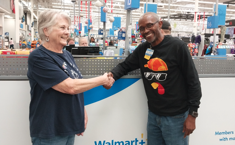 Maurice Jones, Store Manager of Hartwell Walmart presents check to Claudia Kay,  Love Him Love Them Volunteer, in support of the Thanksgiving Day Event.  Over 5,000 meals were prepared and delivered.