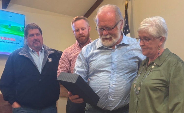 Pictured above (from left to right): Commissioners Joey Dorsey, Jeff Brown and Marshall Sayer present retiring county clerk Lawana Kahn with a plaque commemorating her four decades of service.
