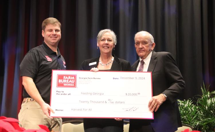 2024 Georgia Farm Bureau Young Farmer Committee Chair Cleve Jackson, left, and GFB President Tom McCall, right, present a check for the proceeds of the 2024 Harvest for All campaign to Georgia Food Bank Association Executive Director Danah Craft (center) during the 2024 GFB Annual Convention on Jekyll Island. Photo courtesy of Georgia Farm Bureau.