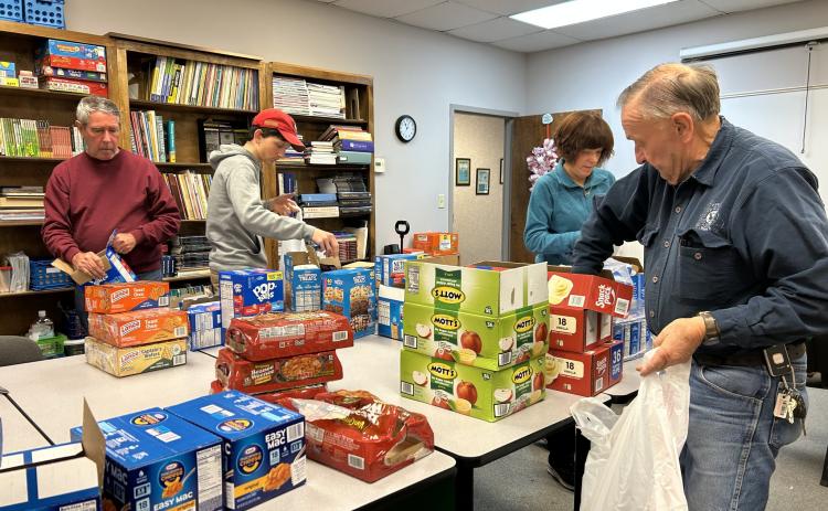 As an integral component of Friday Backpack, operated by Hart Partners, community volunteers gather each week at agency’s downtown office to fill bags with shelf-stable food to be delivered to North Hart, South Hart and Hartwell elementary school students who are referred to the program. Filling the bags are, from left: Greg Blatt, Hubble Kay, Lori Blatt and John Mead.