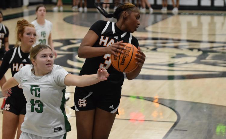 Junior forward Kiasia Montgomery reels in one of her eight rebounds in the 68-51 loss to Franklin County on Jan. 14 in the Lion’s Den. Photo by Shane Scoggins/Franklin County Citizen Leader.