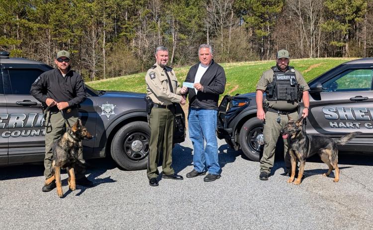 Pictured during a donation to purchase a third drug dog for the Hart County Sheriff’s office are (L-R) Deputy Steve Williams and Jax, Sheriff Chris Carroll, Matt Denton and Deputy Luke Bennett and Zeek.