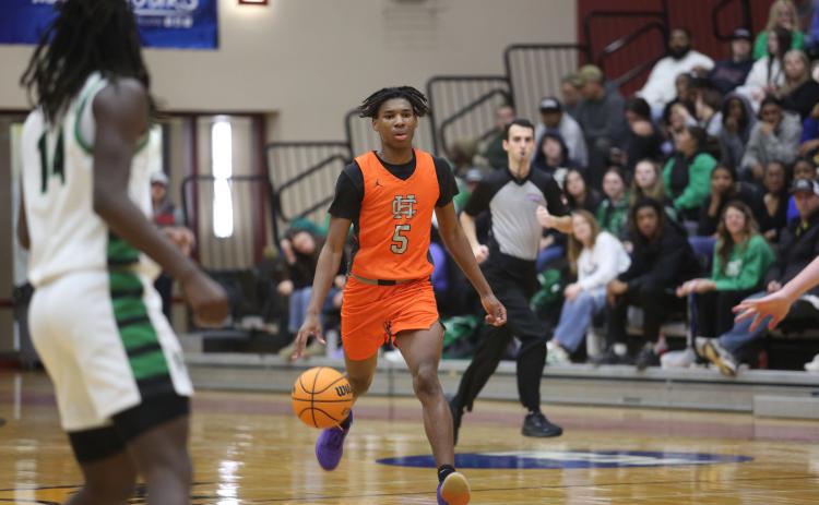 Junior forward Ramarcus Simpson brings the ball up the court in the 79-63 loss to Franklin.