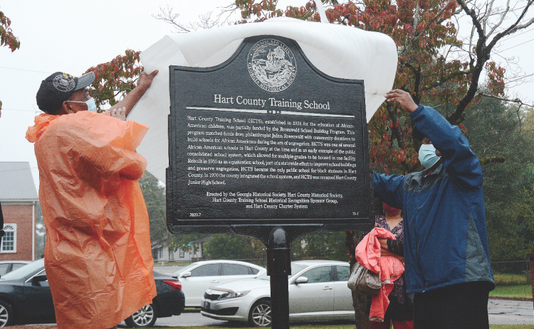 Thomas Morrison, left, and Michael Partlow, right, unveil the new historical marker from the Georgia Historical Society at the former Hart County Training School on Richardson Street on Oct. 10, 2020. Photo by former editor/publisher Michael Hall.