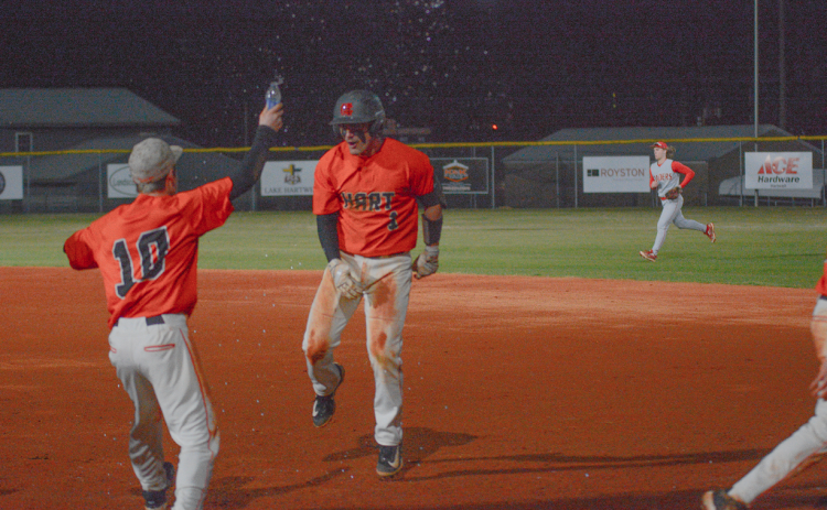 Junior outfielder Boston Graham (right) celebrates with teammates after walking it off against the Red Raiders of Madison County in the 2-1 win on Feb. 24 at Saye Field.